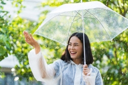 Seorang Wanita Yang Bahagia Di Tengah Hujan. Sumber Shutterstock
