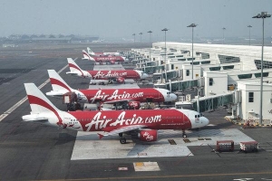 AirAsia aircraft parked at Kuala Lumpur International Airport. A plane similar to these is missing. Credit Ahmad Yusni/European Pressphoto Agency 14197458191367137288