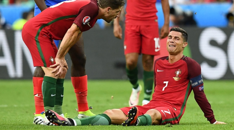 Portugal's forward Cristiano Ronaldo reacts as he sits on the pitch during the Euro 2016 final football match between France and Portugal at the Stade de France in Saint-Denis, north of Paris, on July 10, 2016. Franck Fife / AFP