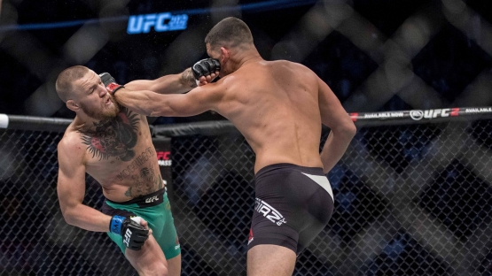 Connor slipping and lands a straight left. Photo by Getty Image