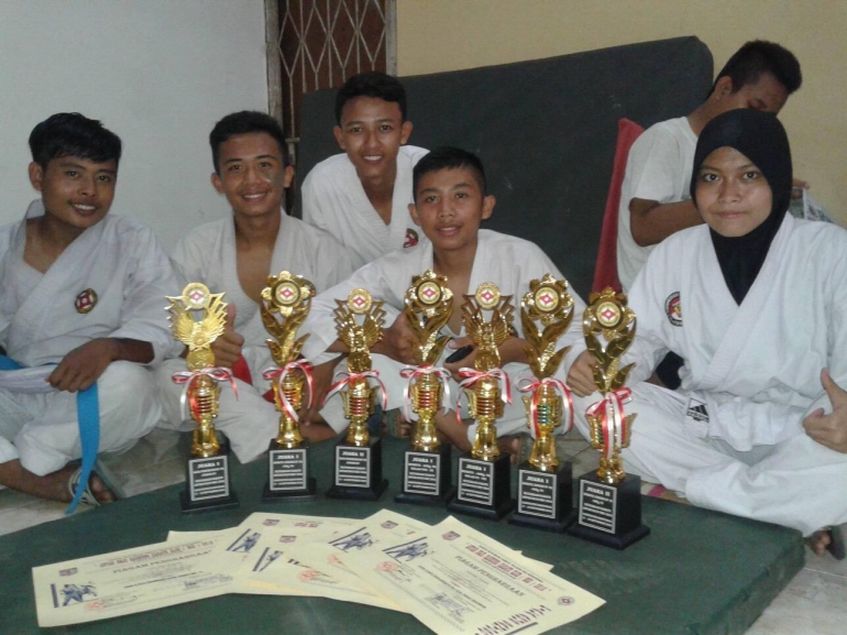 Foto bersama piala dan piagam kemenangan usai pertandingan.