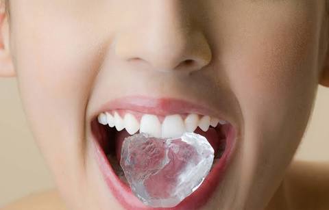 Chewing ice cubes I www.dentalplans.com