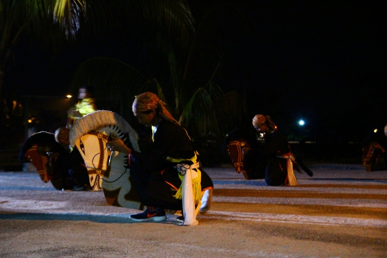 Dancers and their flat horses ready to dance.