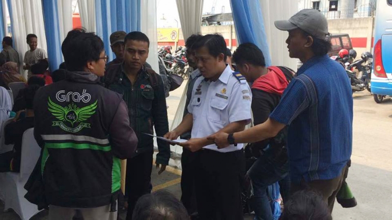 Petugas dari Kemenhub tengah memeriksa kelengkapan dokumen saat pemudik mendaftarkan sepeda motornya untuk diangkut secara gratis menuju Semarang dengan kapal laut. Sumber foto: Pribadi (Sri Hartati)
