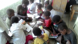 Anak- anak Papua menyimak beragam bacaan (foto: dok Kristina)