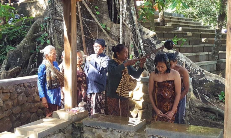 Pasangan suami istri Miyanto dan Leni melakukan siraman yang menjadi bagian dari upacara mitoni (dok. pri).