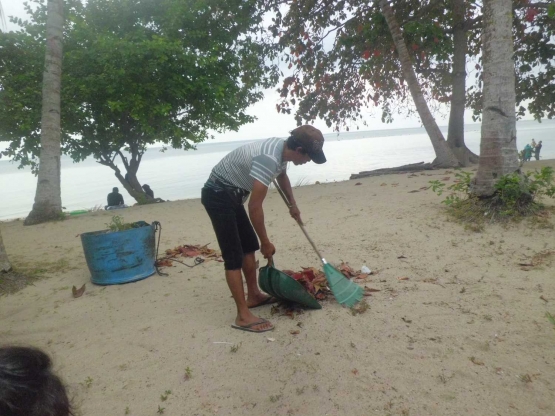 Agar pantai tetap bersih daun dan sampah disapu. | Dokumentasi Pribadi