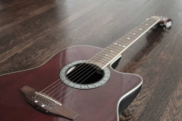 https://goodstock.photos/wp-content/uploads/angled-red-acoustic-guitar.jpg