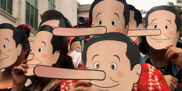 Para aktivis Thailand berdemonstrasi mengenakan topeng Pinokio untuk menyindir PM... dan Junta Militer telah berbohong dengan menunda pemilu. Foto: reuters.com