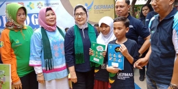 Menkes memberikan secara simbolis buku KIE kesehatan berupa buku tulis dan rapor kesehatan kepada SDN I Limboto, Gorontalo. . (Foto Ganendra)