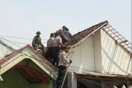Anggota TNI - Polri Sedang Membenahi Atap Rumah Warga Di WIlayah Kecamatan Jetis, Mojokerto