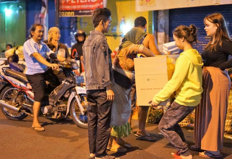 Bersama relawan Manda dan kawan pertukaran pemuda Rotary membagikan makanan (Foto : Lina Soeratman)