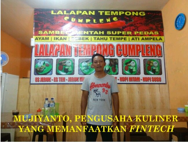 Mas Mujiyanto, di depan banner usahanya (Sumber: dokumen pribadi)
