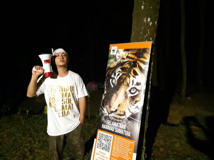Gambar 1: Tuan Tiga Belas berpose disamping poster kampanye selamatkan harimau Sumatera saat launching album " Last Roar" bersama WWF Indonesia, doc Nico kompas