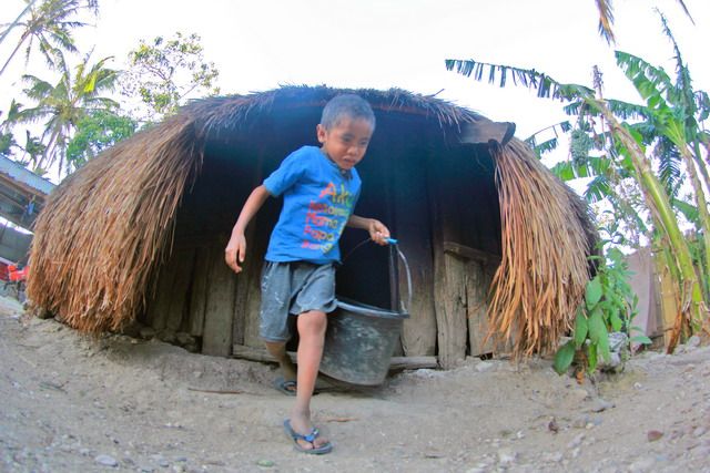 Anak kecil sedang mengambil persediaan air untuk diberikan pada babi-babi peliharaannya | dokpri.