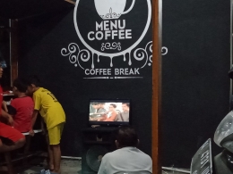 Di beberapa warung kopi kadang ada TV LED berukuran besar untuk acara nonton bareng. Saat itu ada siaran pertandingan sepakbola di satu stasiun swasta (dokpri)