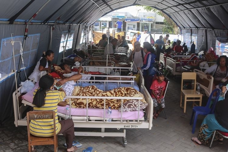 Sejumlah pasien menjalani perawatan di dalam tenda darurat di teras RSUD Haulussy, Ambon, Maluku, Kamis (26/9/2019). Sejumlah pasien kini menjalani perawatan di tenda-tenda yang dibangun di pelataran halaman parkir rumah sakit pascagempa bumi dengan kekuatan magnitudo 6,8. (ANTARA FOTO/IZAAC MULYAWAN)