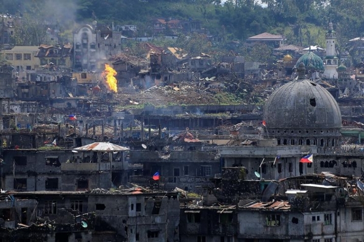 Damaged buildings in war-torn Marawi City after government troops cleared the last area of pro-ISIS militants yesterday. More than 1,000 militants, government troops and civilians have been killed in the conflict which began on May 23.PHOTO: REUTERS