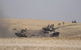Turkish tanks and troops stationed near Syrian town of Manbij, Syria, Tuesday. Oct. 15, 2019..(Ugur Can/DHA via AP)