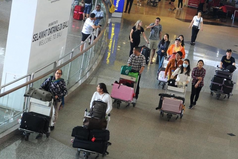 Sejumlah wisatawan membawa barang bawaan setibanya di Terminal Kedatangan Internasional Bandara Internasional I Gusti Ngurah Rai, Bali, Rabu (22/1/2020). (Katadata.co.id)