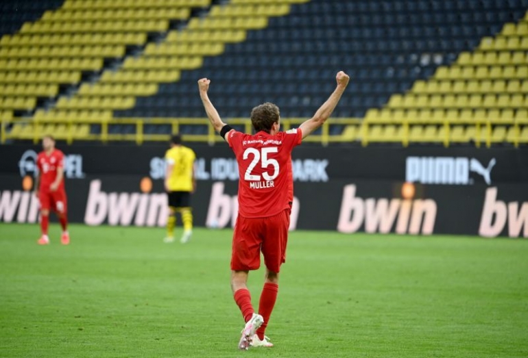 Pemain Bayern Munchen, Thomas Muller merayakan kemenangan timnya di markas Borussia Dortmund pada pertandingan Bundesliga pekan ke-28, Rabu (27/5) dini hari tadi. Bayern semakin berpeluang juara. Sementara kekalahan Dortmund menjadi daftar panjang tim tuan rumah yang gagal menang sejak era new normal/Foto: sports.yahoo.com