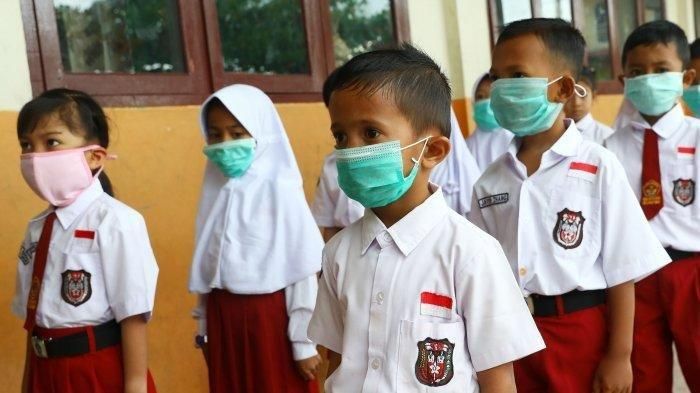 Siswa sekolah dasar negeri 002 Ranai melakukan aktivitas belajar menggunakan masker di Kabupaten Natuna, Kepulauan Riau, Indonesia, Selasa (4/2/2020). Bulan Juli, murid sekolah akan kembali masuk sekolah seperti sebelum masa pandemi corona. (TRIBUNNEWS/IRWAN RISMAWAN) 