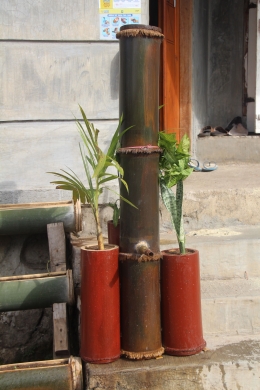 Rumah warga dengan bambu wadah air di depannya (dokpri)