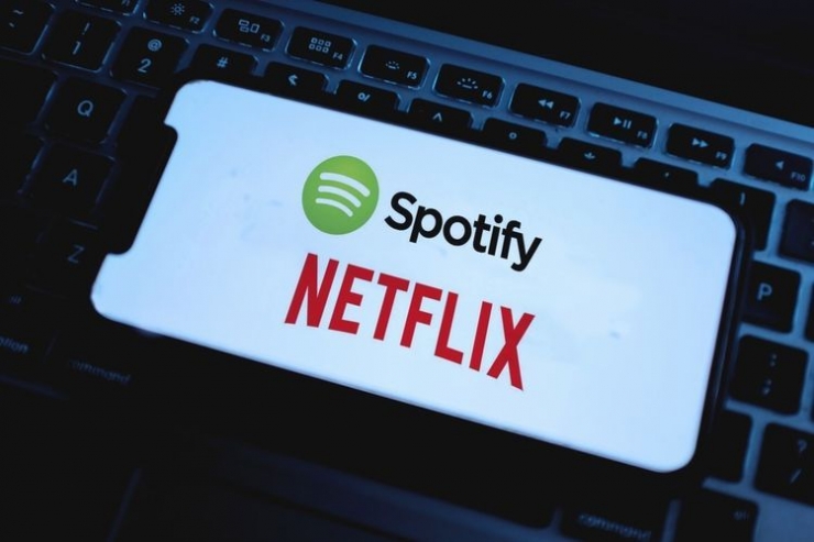 Ilustrasi platform streaming Netflix dan Spotify. (Shutterstock via tekno.kompas.com)