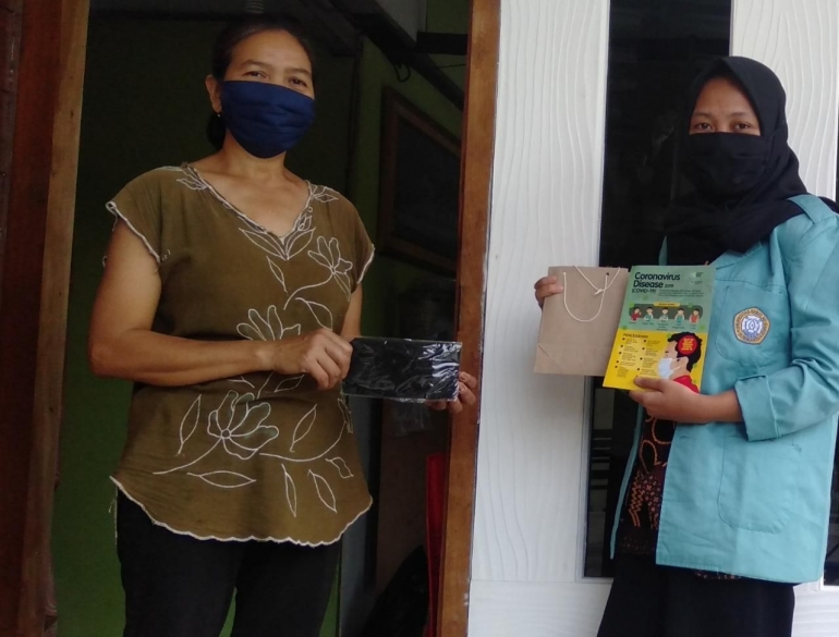 Mahasiswa KKN UNS, Riska Widya Sari membagikan masker kain dan edukasi kepada Ibu Yanti, salah satu warga Sitimulyo RT. 7/11 Cepu.dokpri