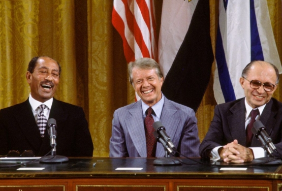 Egyptian President Anwar Sadat, U.S. President Jimmy Carter and Israeli Prime Minister Menachem Begin share a laugh at the signing of the Camp David Accords on September 17, 1978. ( David Hume Kennerly/Getty Images)