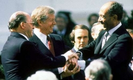 U.S. Pres. Jimmy Carter (second from left), Israeli Prime Minister Menachem Begin (left), and Egyptian Pres. Anwar Sadat clasping hands on the White House lawn after the signing of the peace treaty between Israel and Egypt, March 26, 1979. Bettmann/Corbis