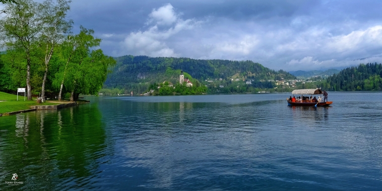 Panorama danau dengan Pletna menuju pulau. Sumber: koleksi pribadi