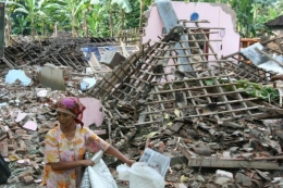 seorang Ibu dan reruntuhan rumah (27/05/2006) akibat gempa Bantul di Dusun Bondalem Bantul (sumber gambar: www.kompas.com/)