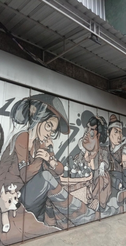 Lukisan mural tukang jamu dan seorang wanita yang memakai caping. [Dokumentasi Pribadi]