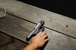 https://www.pexels.com/photo/person-holding-black-semi-automatic-pistol-5202395/