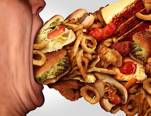 Orang rakus makan Sumber: istockphoto.com/photos/greedy