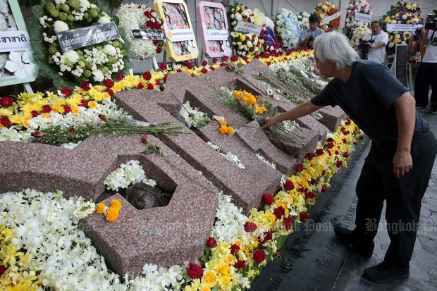 Seorang pria meletakkan bunga di monumen yang memperingati Pembantaian 6 Oktober | Foto diambil dari Bangkok Post