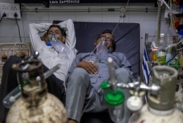 Satu tempat tidur ditempati 2 pasien Covid-19. Photo: Danish Siddiqui/Reuters