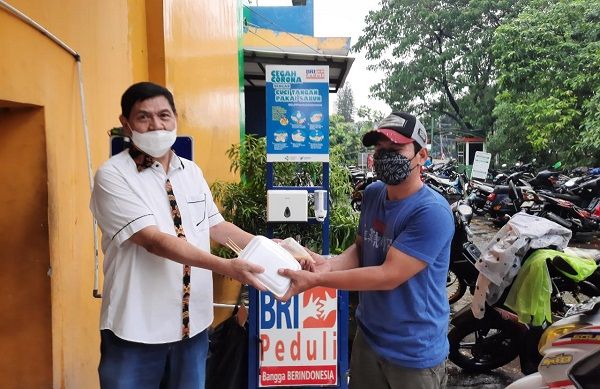 Ketua Koppas Ciracas Budianto Sugianto (kiri) membagikan makanan buka puasa ke pengunjung Pasar Ciracas, Rabu (28/4/2021)/Foto: istimewa/dokpri