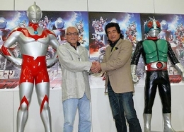 Susumu Kurobe (Takashi Yoshimoto, pemeran Ultraman) berjabat tangan dengan Hiroshi Fujioka (Kunihiro Fujioka, pemeran Kamen Raider). Sumber: Toei Corporation.