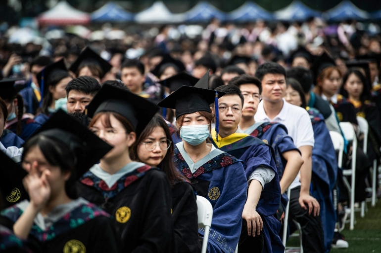 This photo taken on June 13, 2021 shows nearly 11,000 graduates, including more than 2000 students who could not attend the graduation ceremony last year due to the COVID-19 coronavirus outbreak, attending a graduation ceremony at Central China Normal University in Wuhan, in China's central Hubei province. (AFP)