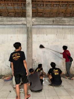 Proses Pembersihan Kotoran di Tembok Balai Dusun Kepuh Selatan Sebelum di Catoleh Mahasiswa KKN UM 2021 dan Karang Taruna
