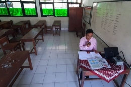 Guru Kelas VI MIN 8 Gunungkidul Ahmad Satibi Sedang Mengajar Menggunakan HT Selasa (25/8/2020)(KOMPAS.COM/MARKUS YUWONO) 