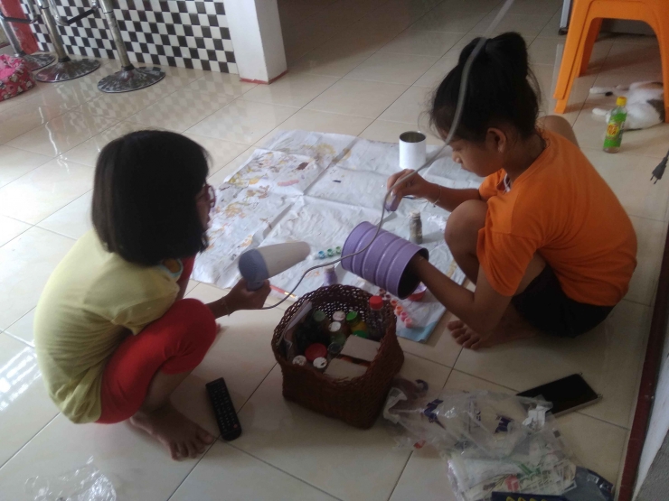 Nailah dan Icha mengecat kaleng bekas susu. (foto : Elvidayanty Darkasih)