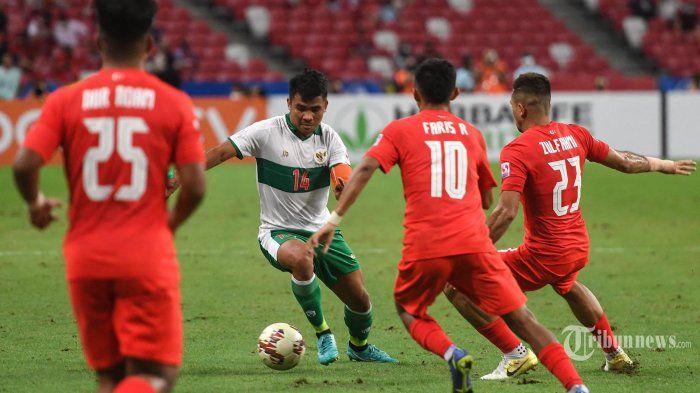 Asnawi Mangkualam dikepung tiga orang pemain Singapura dalam semi final leg pertama Piala AFF 2020 (22/12) (Sumber : tribunnews.com)