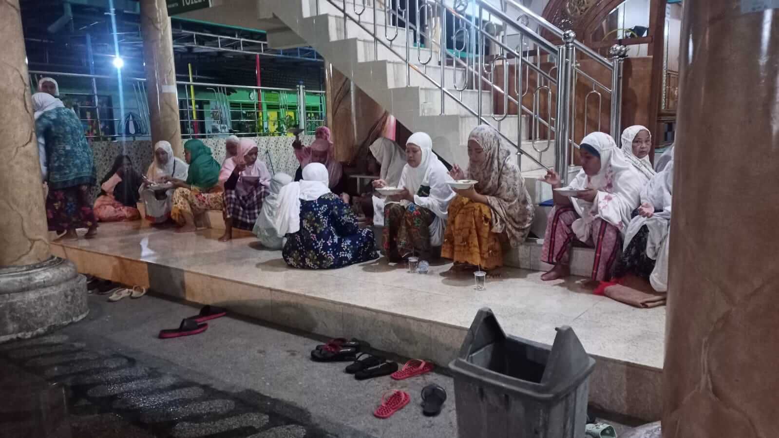 Jamaah ibu-ibu asyik menikmati makan sahur menu soto daging