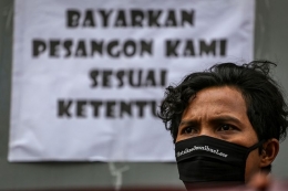 Seorang buruh mengikuti aksi unjuk rasa di depan pabrik tempat mereka bekerja di Benda, Kota Tangerang, Banten, Jumat (1/5/2020). (ANTARA FOTO/FAUZAN)