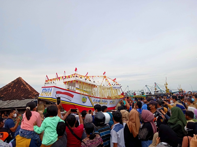 Pengangkatan kepala kerbau dan sesaji menuju perahu larung (Dok. Pribadi)