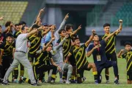  Ekspresi kegembiraan Timnas Malaysia U-19 (Foto: MPI/ALDHI CHANDRA SETIAWAN) 