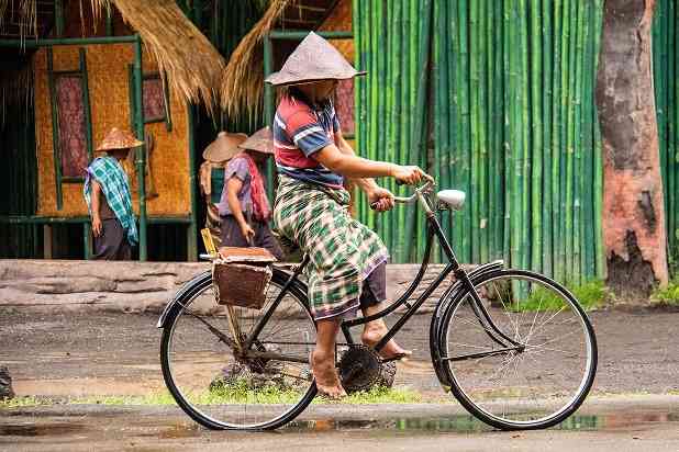 Ilustrasi gambar orang desa bersepeda (Unsplash - Nick Fewings)